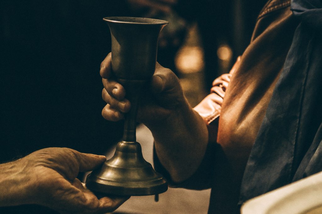 a person holding a chalice