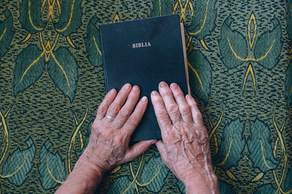 Two people holding a Bible