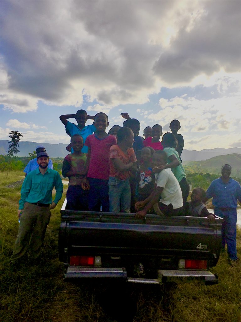 Children in back of truck riding along with Matt